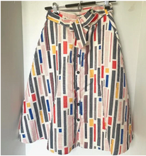 Load image into Gallery viewer, Colorful patterned shirt on a hanger against a white background