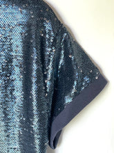 Load image into Gallery viewer, Close-up of a sequined garment, likely a top or dress, featuring light blue and dark navy sequins with a solid navy blue sleeve cuff, shown against a plain off-white background.
