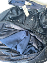 Load image into Gallery viewer, A close-up of a dark blue sequined fabric garment, likely a dress or top, with a matching blue inner lining or underlayer visible in a folded section. A white product tag is attached near the neckline.