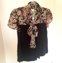 Load image into Gallery viewer, Black dress with floral accents on a hanger against a white background