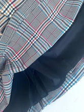 Load image into Gallery viewer, A close-up of a plaid blazer or jacket with a black lining, showing the pattern details of red, blue, and white over a black base.