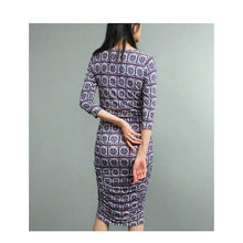 Load image into Gallery viewer, Woman wearing a patterned dress against a gray background