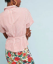 Load image into Gallery viewer, A woman shown from the back wearing a pink and white vertically striped short-sleeve shirt with a tie waist, paired with a red and green floral print skirt, against a light blue background.