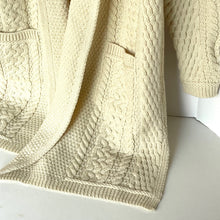 Load image into Gallery viewer, Close-up of a beige cable knit sweater on a white background