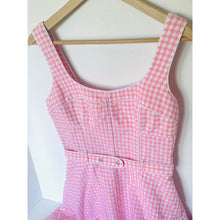 Load image into Gallery viewer, Pink gingham dress on a wooden hanger against a white background