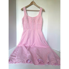 Load image into Gallery viewer, Pink gingham dress on a hanger against a white background