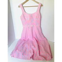Load image into Gallery viewer, Pink checkered dress on a hanger against a white background