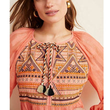 Load image into Gallery viewer, Woman wearing a patterned top with a peach-colored cardigan on a beige background