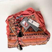 Load image into Gallery viewer, Colorful patterned fabric with tassels and tags on a white background
