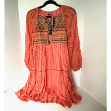 Load image into Gallery viewer, Coral dress with intricate patterns on a hanger against a white background