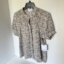 Load image into Gallery viewer, Animal print shirt on a hanger with a visible brand tag against a white background