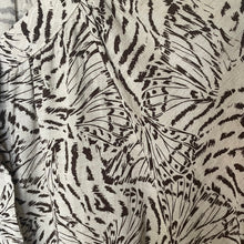 Load image into Gallery viewer, Close-up of fabric with black abstract pattern on a beige background