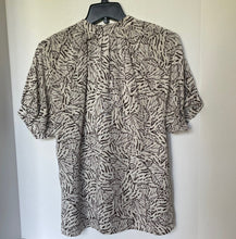 Load image into Gallery viewer, Patterned dress on a hanger against a white background