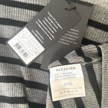 Load image into Gallery viewer, Close-up of a Herskind label on a striped garment with visible text and branding.