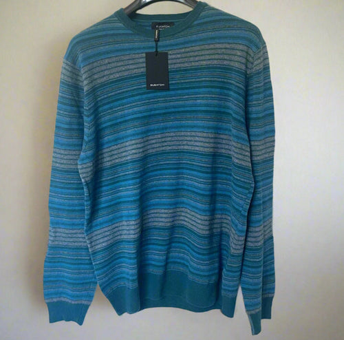 Blue striped sweater on a hanger with a plain background