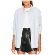 Load image into Gallery viewer, Woman wearing a light blue button-up shirt and black leather skirt on a white background
