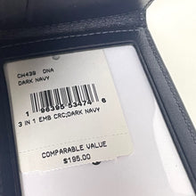 Load image into Gallery viewer, Label on a dark navy leather product with text and barcode