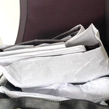 Load image into Gallery viewer, Stack of white plastic bags on a dark surface