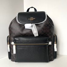 Load image into Gallery viewer, Black Coach backpack with patterned design on a white background