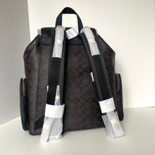 Load image into Gallery viewer, Black backpack with patterned straps on a white background