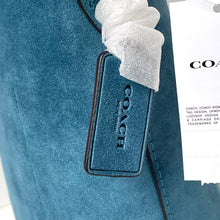Load image into Gallery viewer, Blue Coach bag with a tag and white towel on a white background