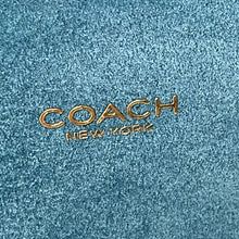 Load image into Gallery viewer, Coach New York logo on a textured blue background
