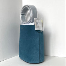 Load image into Gallery viewer, Blue bag with a gray hood and pocket against a white background