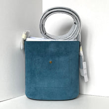 Load image into Gallery viewer, Blue crossbody bag with a strap and items on a white background