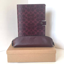 Load image into Gallery viewer, Coach leather product with patterned cover and pouch on a beige box