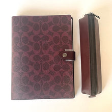 Load image into Gallery viewer, Maroon patterned leather cover with zipper on a beige background
