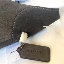 Load image into Gallery viewer, Dark gray suede shoe with a Coach tag on a light background