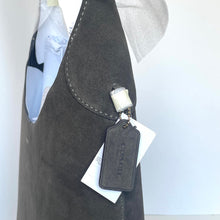 Load image into Gallery viewer, Gray apron with a brand tag on a white background