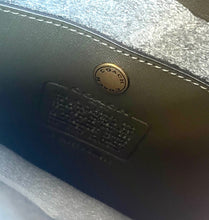 Load image into Gallery viewer, Close-up of a Coach logo on a leather product