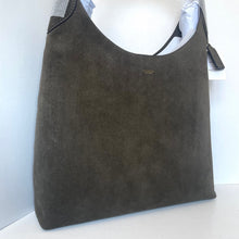 Load image into Gallery viewer, Brown suede handbag on a mannequin with a visible brand logo against a white background