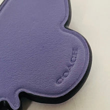 Load image into Gallery viewer, Close-up of a purple Coach product on a white background