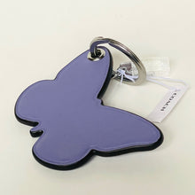 Load image into Gallery viewer, Butterfly-shaped purple keychain with a tag on a white background