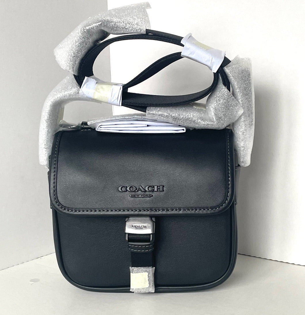 Black Coach bag with silver accents on a white background