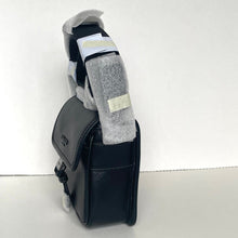 Load image into Gallery viewer, Black leather bag with gray socks inside on a white background