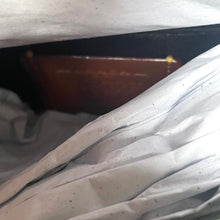 Load image into Gallery viewer, Close-up of a mattress with visible wear and tear