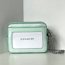 Load image into Gallery viewer, Mint green Coach wallet with chain strap on a light gray background