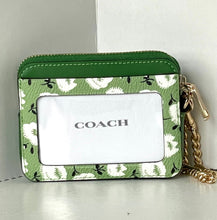 Load image into Gallery viewer, Green Coach wallet with floral pattern on a light gray background