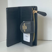 Load image into Gallery viewer, Black wallet with gold zipper and Coach logo on a white background