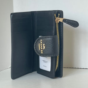 Black wallet with gold zipper and Coach logo on a white background