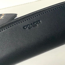 Load image into Gallery viewer, Black leather wallet with 'Coach' branding on a light background