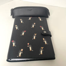 Load image into Gallery viewer, Black planner with penguin design on a white surface