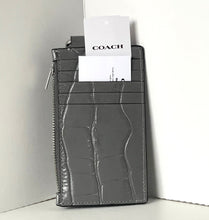 Load image into Gallery viewer, Gray textured wallet with a Coach card on a white surface