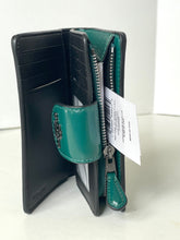 Load image into Gallery viewer, Open black and teal wallet with a visible brand tag on a white background