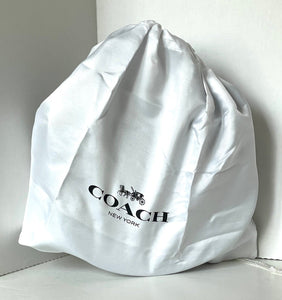 White Coach bag with logo on a light gray background