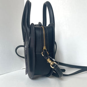 Black leather backpack with gold zipper on a white background