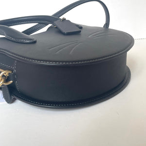 Black handbag with gold accents on a white background